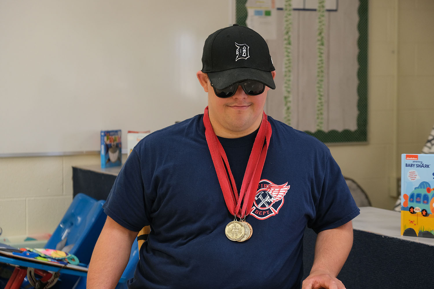 Young man with baseball caps wearing medals